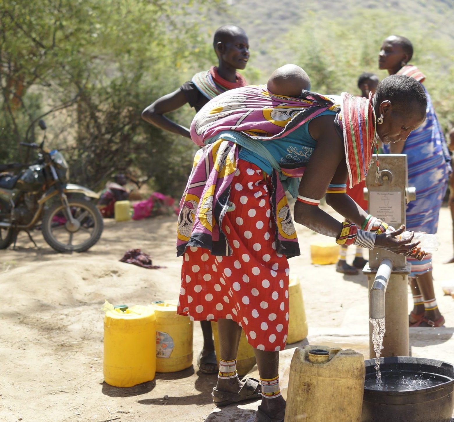 Women drawing water from the Lecher Well, The Samburu Project.