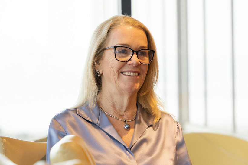 Woman smiling during a conversation in a bright office